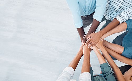 Stacked Hands Representing Teamwork